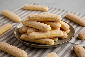Savoiardi biscuits on a plate, side view., a Food & Drink Photo by LiudmylaChuhunova