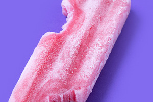 Red strawberry popsicles on purple background. Close up, a Food & Drink Photo by etorres69