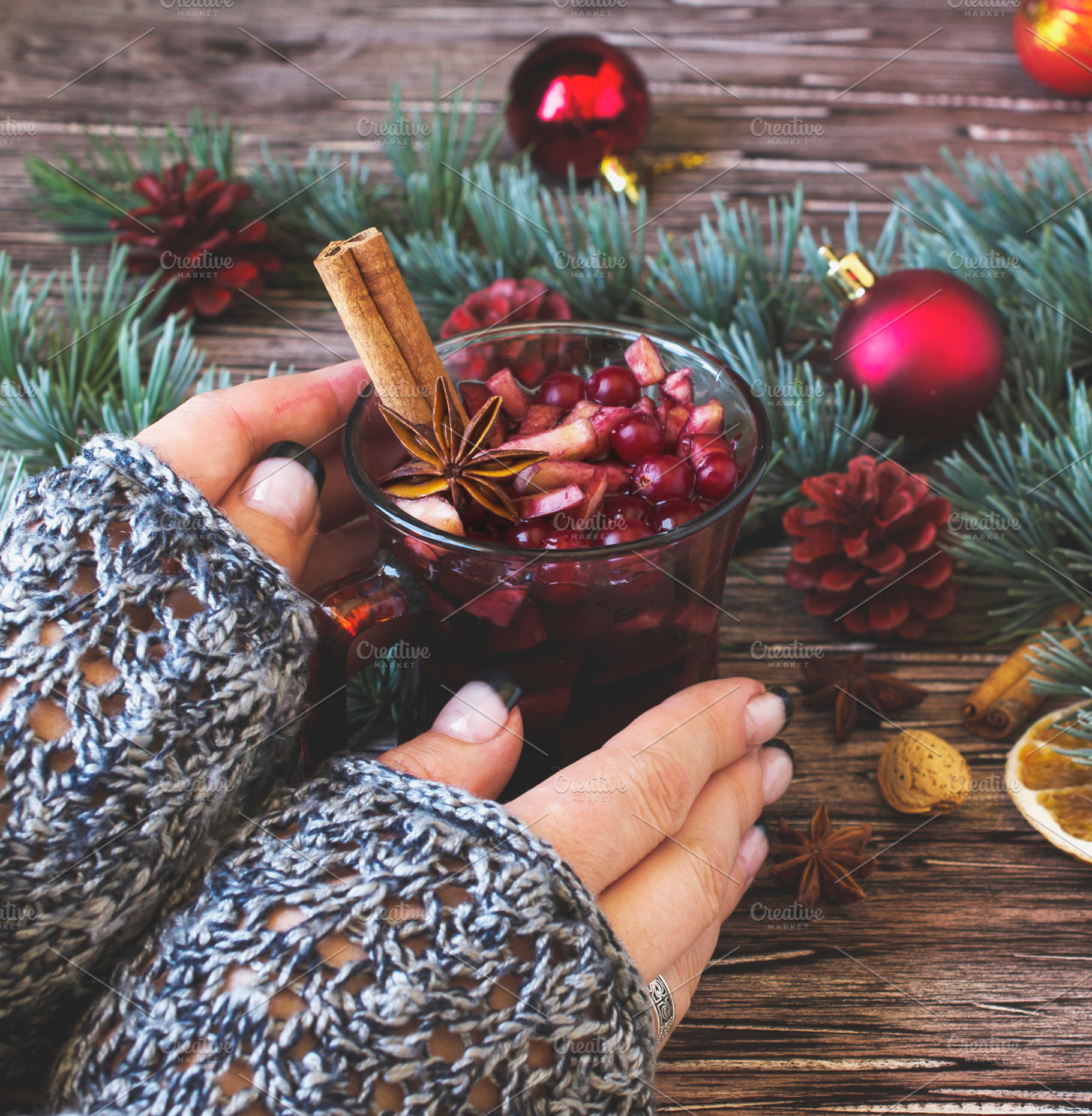 Woman's hands holding a cup of mulled wine between featuring wine, a Holiday Photo by Wild Drago Shop