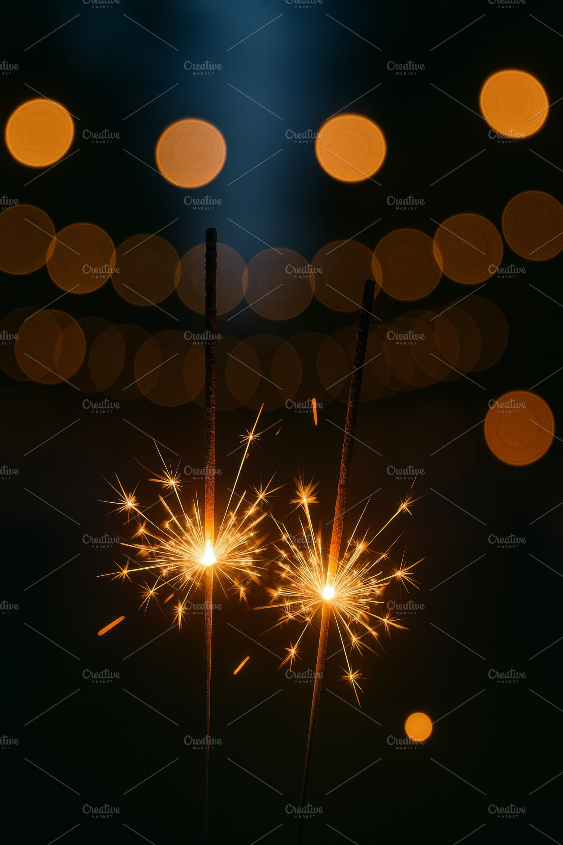 Sparklers glowing against bokeh ligh, a Photo by Dvoevnore photos