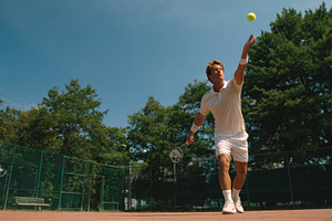 Tennis player serving on outdoor cou, a Photo by Pixeness Studio