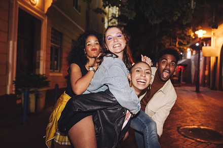 Group of vibrant friends looking at the camera outdoors, a Person Photo by Jacob Lund