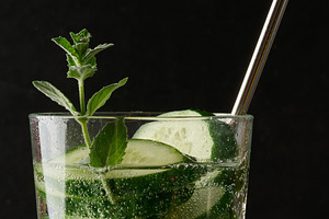 A glass of refreshing detox water with slices of cucumber and a, a Food & Drink Photo by ndanko