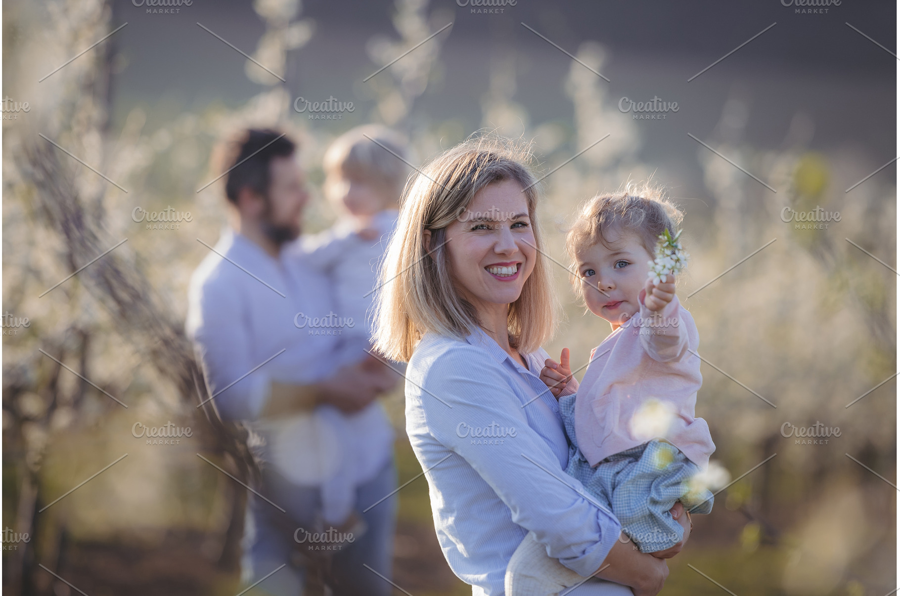 Spring portrait of parents with two, a Person Photo by HalfPoint