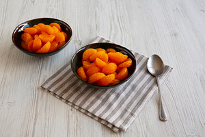 Organic Canned Mandarin Oranges in Bowls, side view., a Food & Drink Photo by LiudmylaChuhunova
