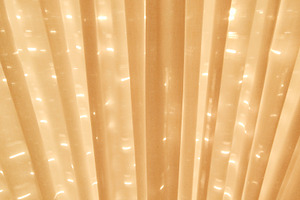 Closed curtains of apartment living room iluminated by the sun o, a Background Photo by DanFLCreativo