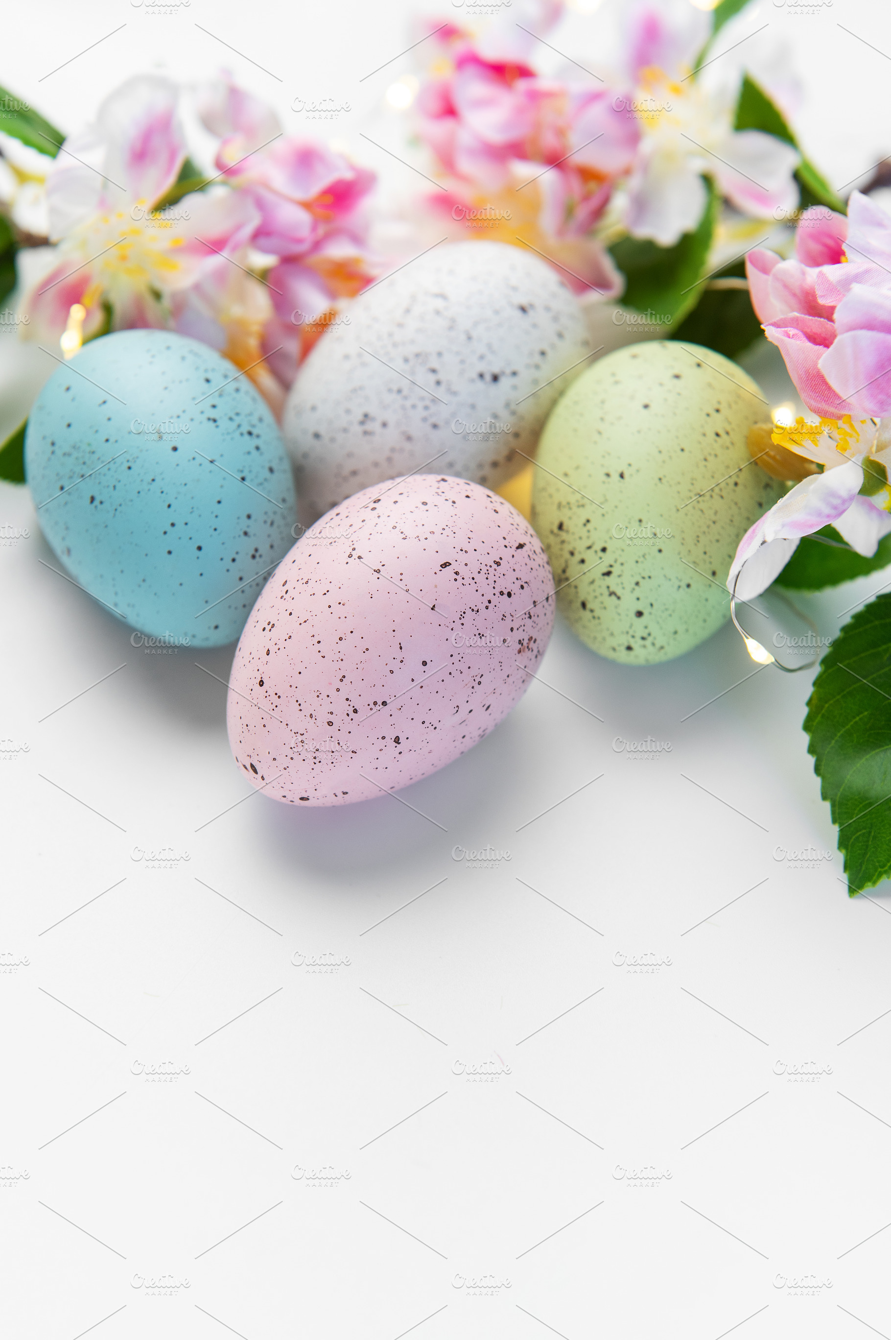 Pastel speckled easter eggs with spring flowers decoration, a Holiday Photo by Olena Rudo