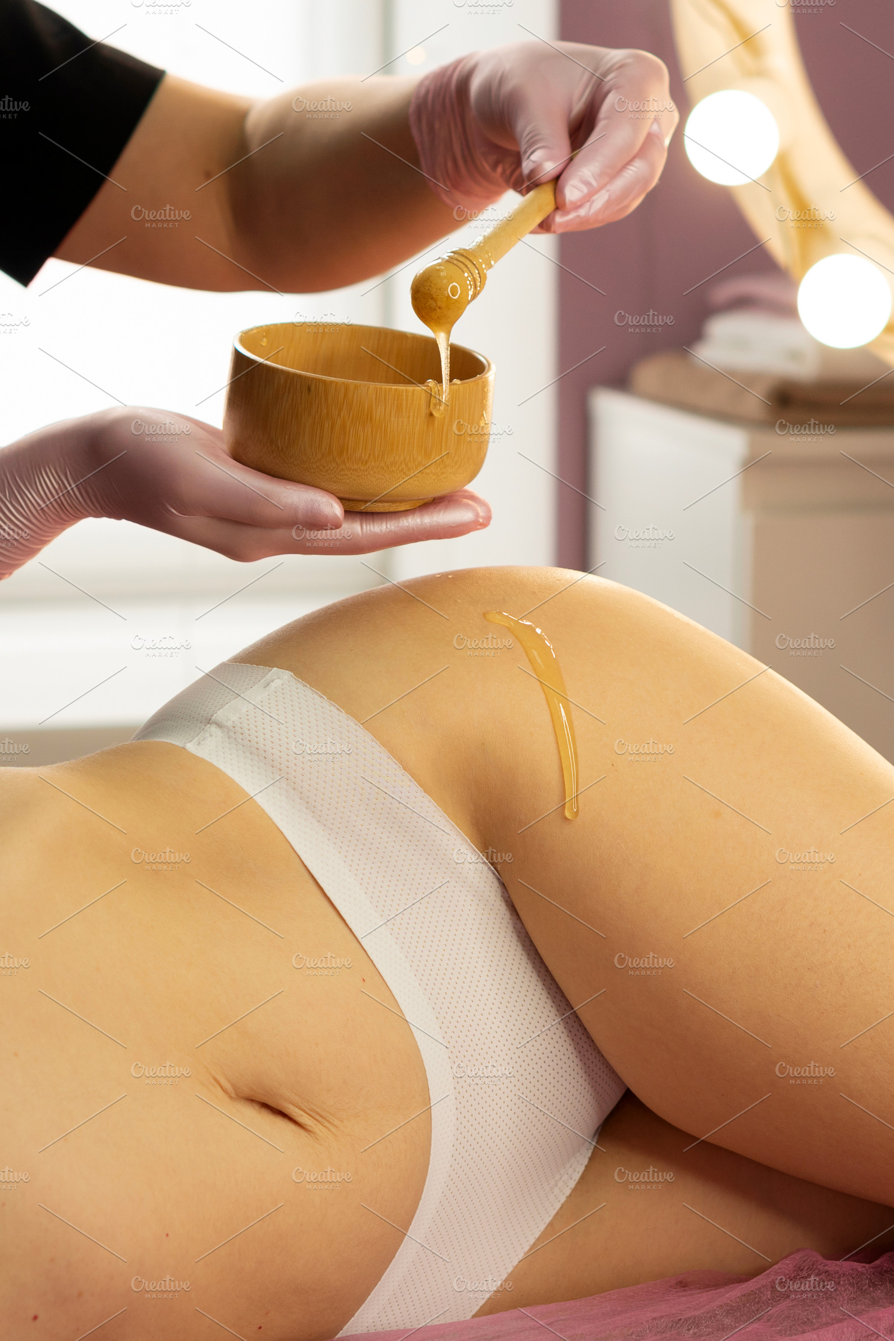 Beautician dripping honey, a Health & Medical Photo by Elena Vagengeim