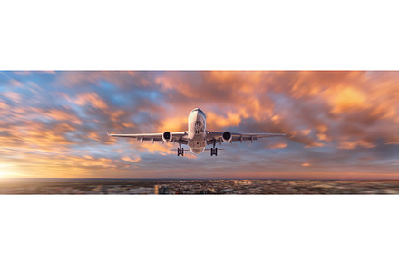 Plane is flying in colorful sky over, a Transportation Photo by den-belitsky