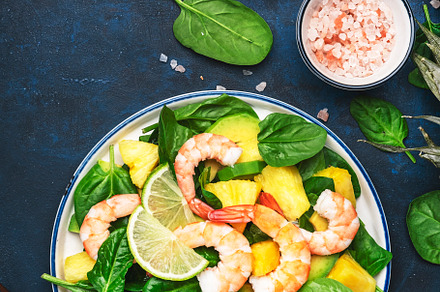 Fresh pineapple salad with shrimps, spinach, avocado and lime on, a Food & Drink Photo by 5PH