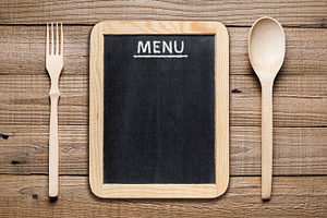 Menu board containing fork, spoon, and wooden, a Food & Drink Photo by Anatoliy Sadovskiy