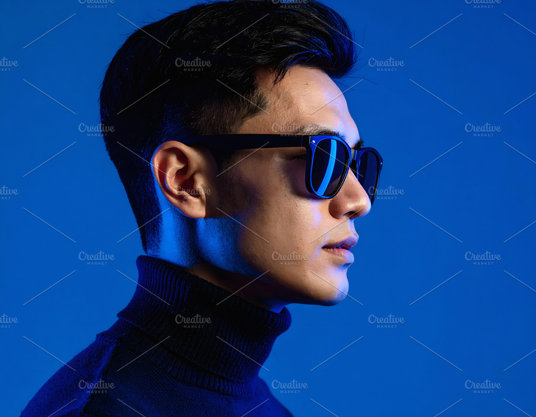 Businessman in black turtleneck posing with sunglasses profile, a Nature Photo by GoodGoods
