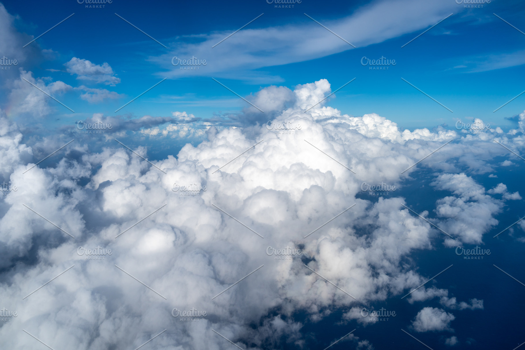 Aerial view of fluffy clouds over the Pacific Ocean in Polynesia, a Photo by GoodGoods