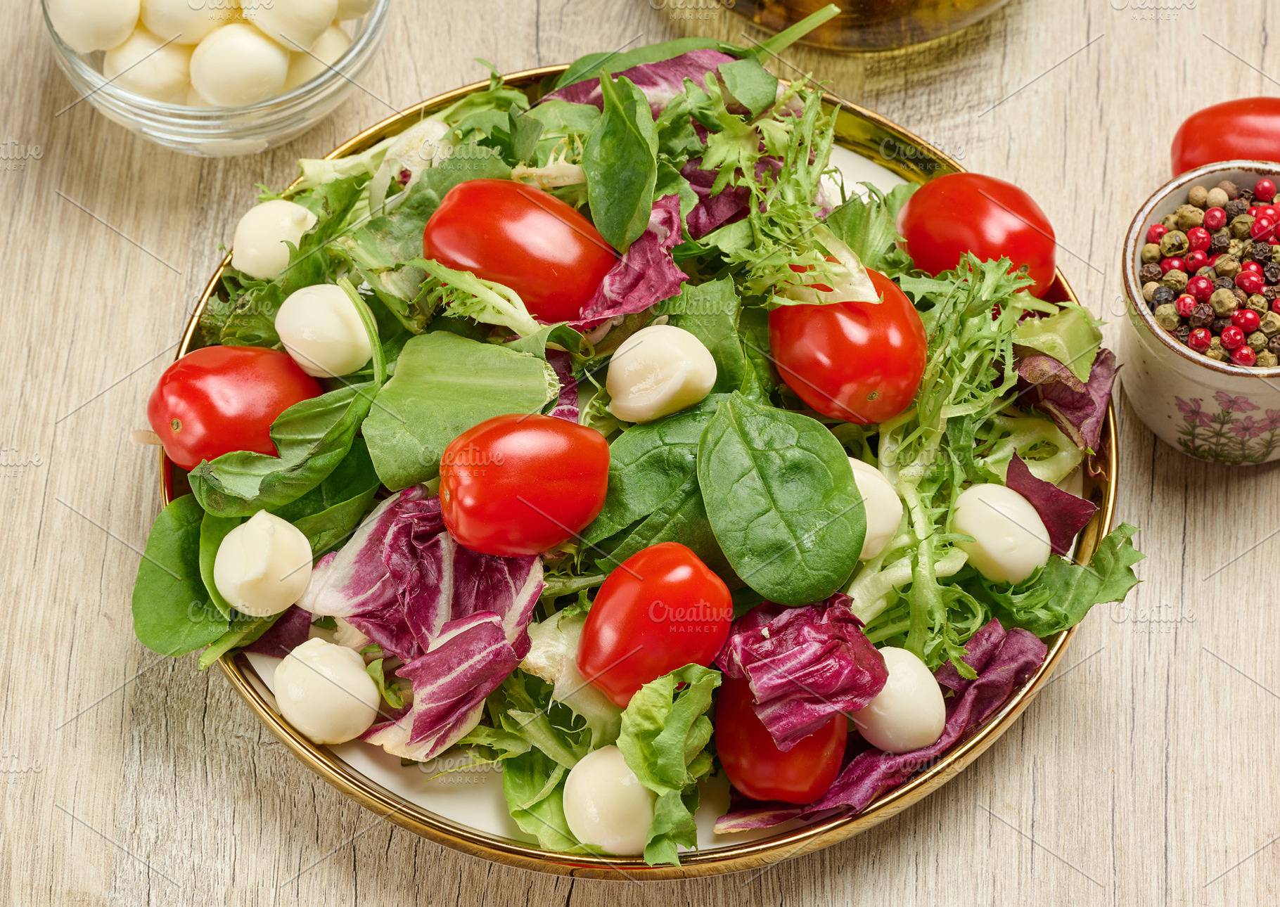 Plate of fresh salad with mixed greens, cherry tomatoes and mozz, a Food & Drink Photo by ndanko