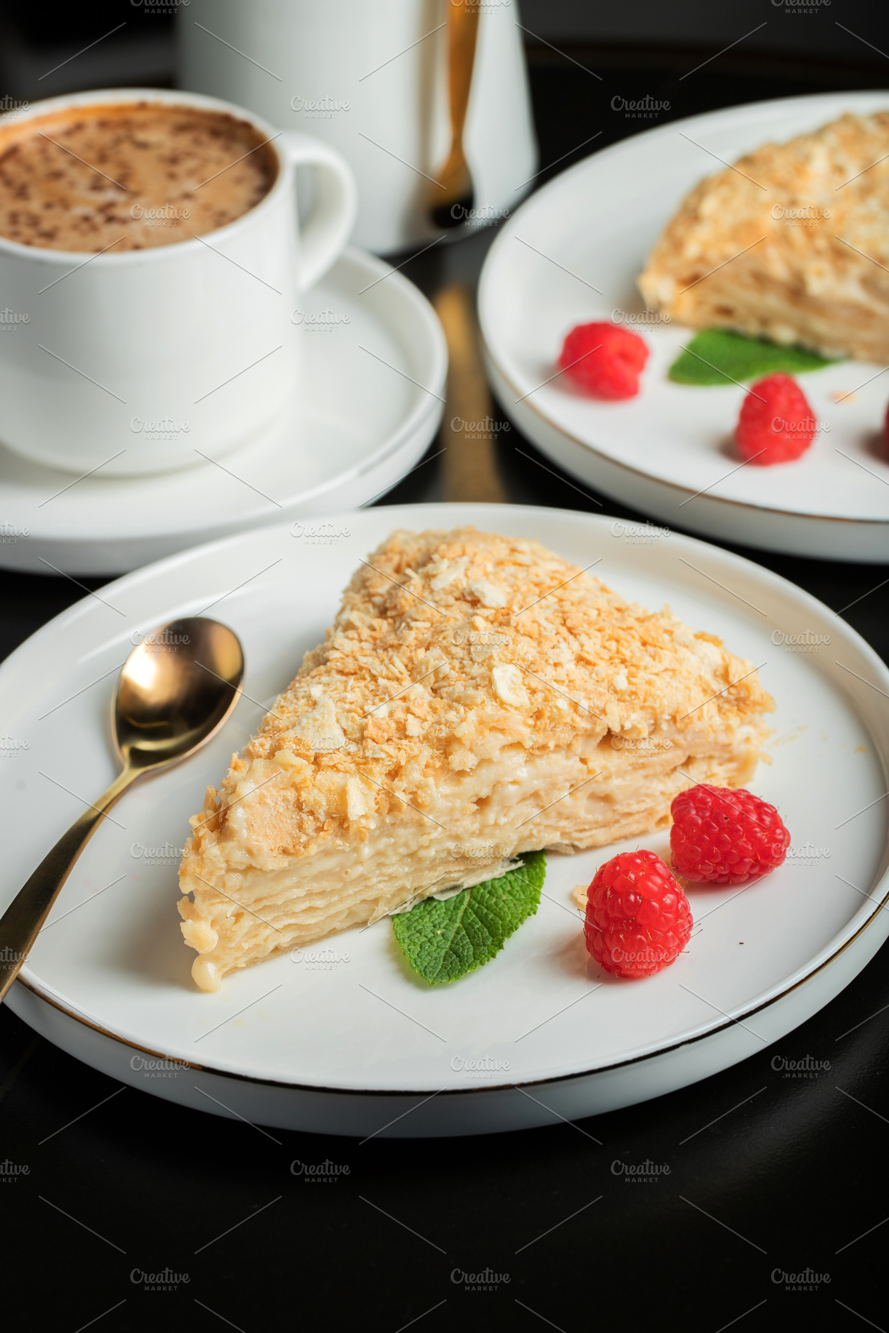 Sliced Napoleon cake on a white wooden table. Classic dessert, a Food & Drink Photo by Budarinphoto