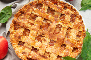 Freshly baked apple pie decorated with apple slices and leaves o, a Food & Drink Photo by Olena Rudo