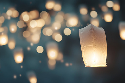 Yi Peng lanterns floating in night sky during Loi Krathong festi
