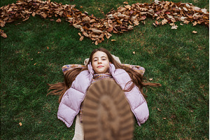Portrait of teen girl laying on, a Person Photo by HalfPoint