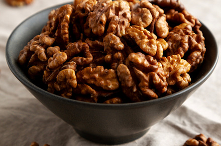 Raw Walnut Halfs in a Bowl, side view.