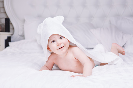 Adorably baby lie on white towel in bed happy childhood and healthcare, a Person Photo by fotoliza