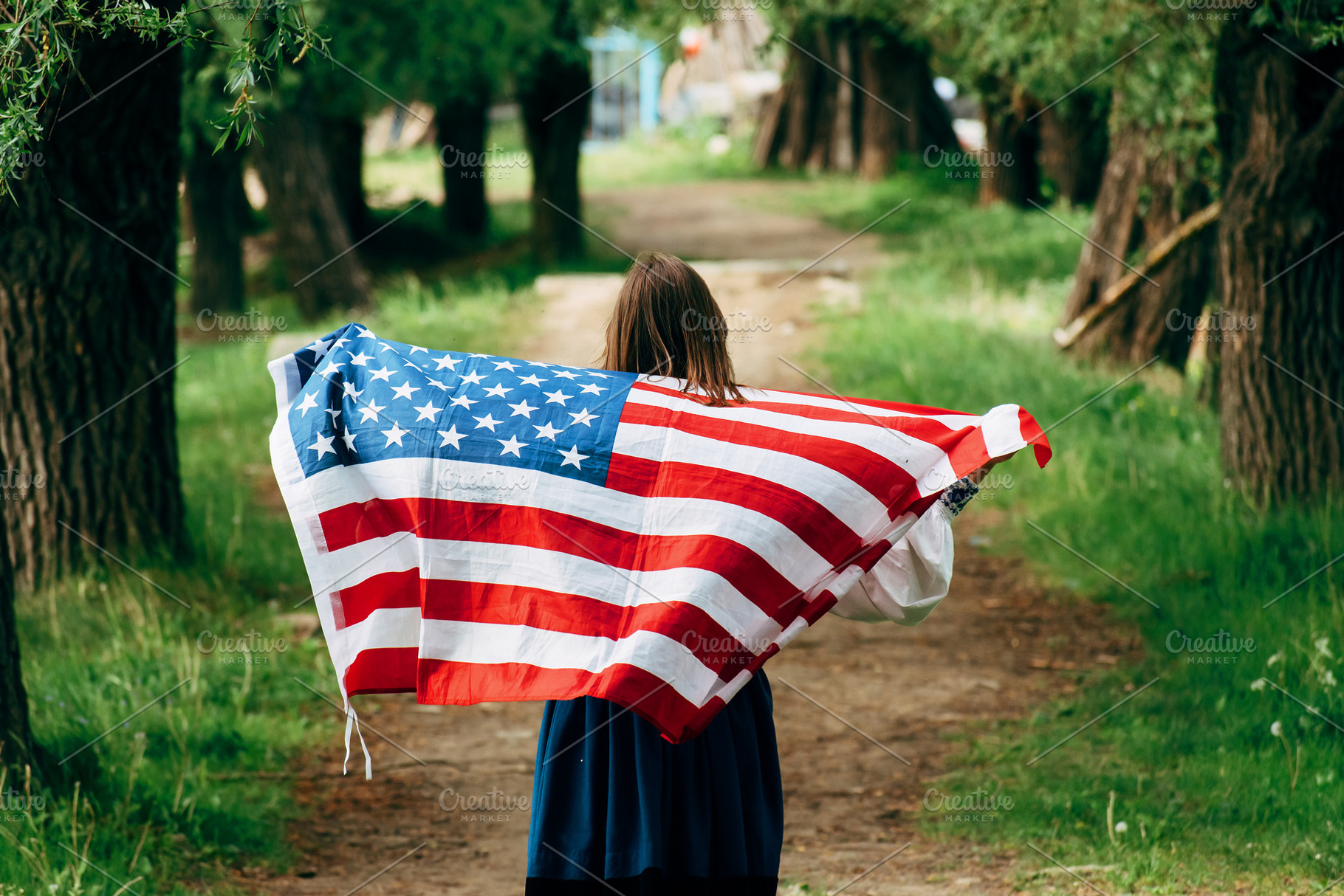 The girl carries the American flag., a Person Photo by Oleksandr Masnyi