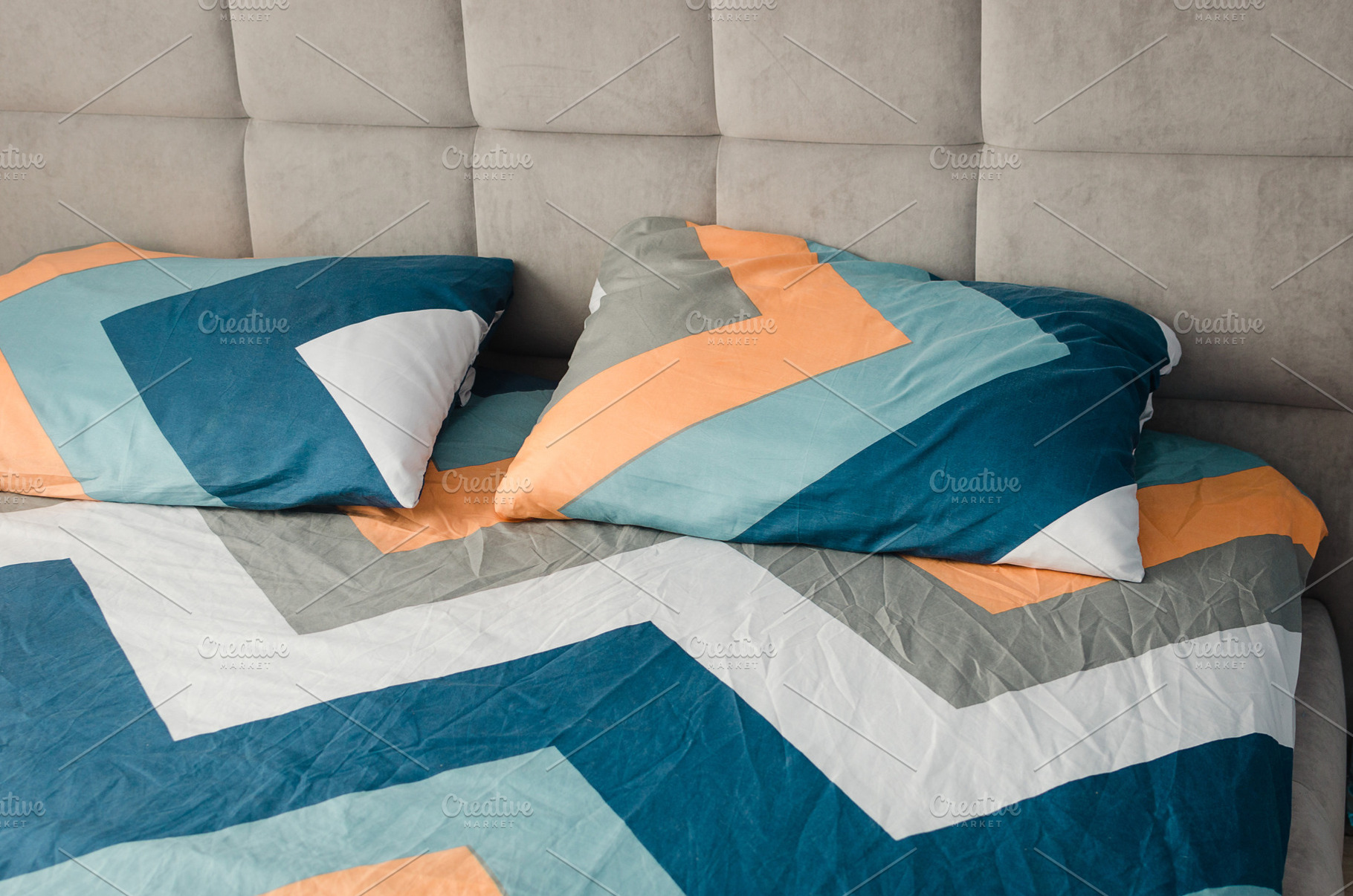 colorful pillows on grey bed in modern bedroom style., a Photo by vimart