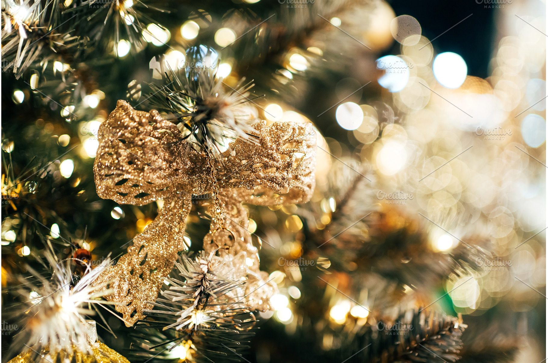 Golden glitter bow decorating a, a Holiday Photo by Anna Efetova