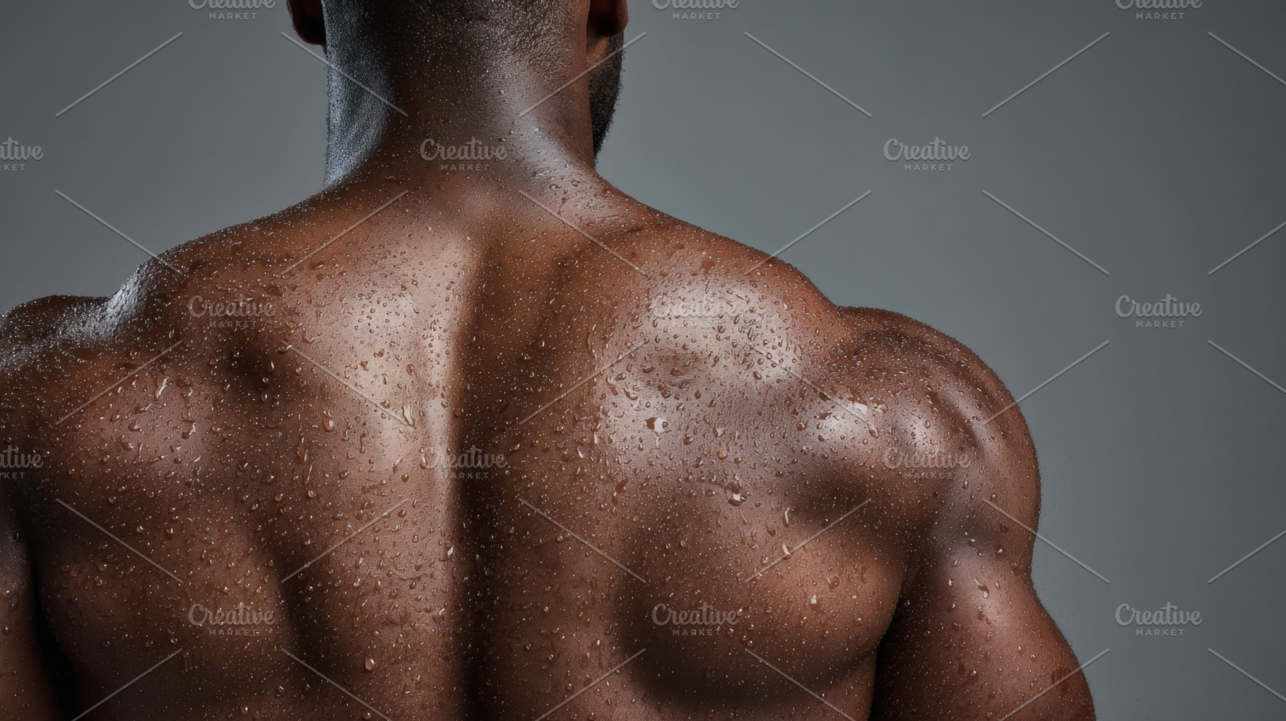 Muscular man with wet back in studio, a Photo by Beautiful things