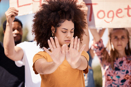 Protest, stop and hands of black woman with people in street for equality, freedom and human rights. Justice, community and group of activist on road in city for black lives matter and social change, a Photo by Peopleimages.com
