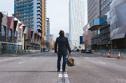 Man standing alone in the street containing action, alone, and back