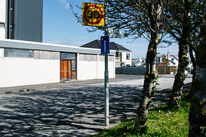 Speed limit sign on a charming suburban street in Akranes, Iceland, a Photo by AS photostudio