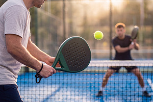 Action shot of padel player hitting a serve with ball floating i, a Sports & Recreation Photo by Volff