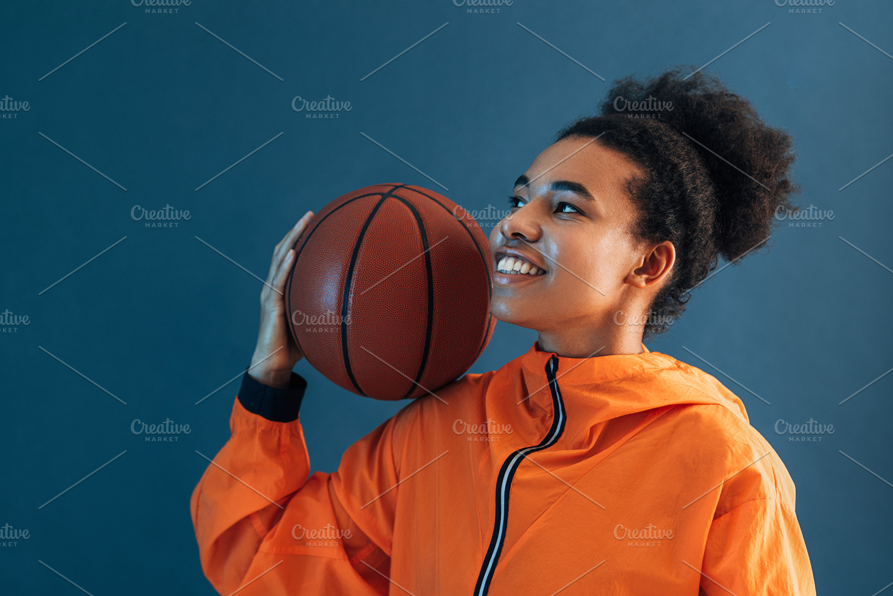 Smiling woman in orange clothes, a Sports & Recreation Photo by Artem Varnitsin
