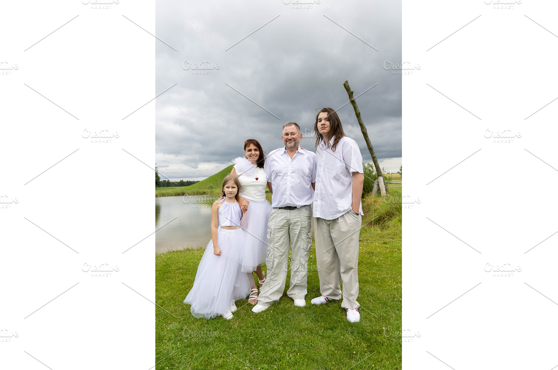 Family posing outdoors in white, a Person Photo by Nenahliadava Design