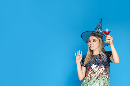 Concept of Halloween, young woman on blue background, a Person Photo by AtlasStudio PRO