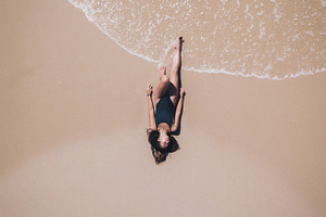 Aerial of Girl tanning on beach
