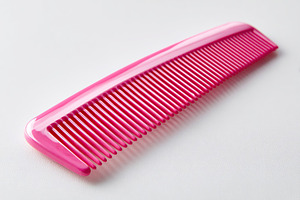 Pink ergonomic comb with smooth grip ideal for styling hair in everyday use, a Beauty & Fashion Photo by AlyaAnd