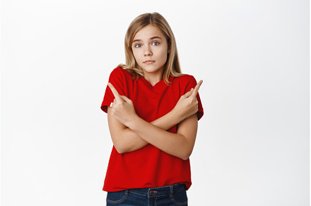 Indecisive little girl shrugs and, a Person Photo by Cookie Studio