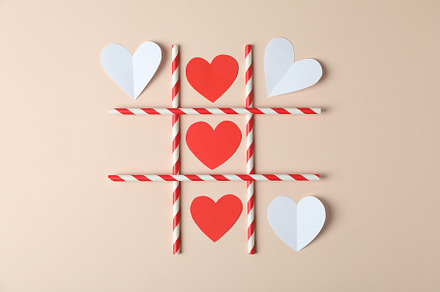 Valentine's Day concept with tic tac toe on beige background, an Arts & Entertainment Photo by AtlasStudio PRO