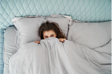 Beautiful woman awake in comfort bed