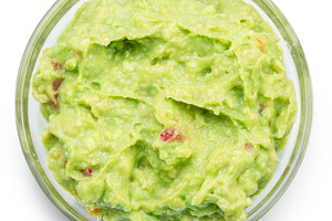 Glass bowl of guacamole on white background. Top view. File cont, a Food & Drink Photo by Volff