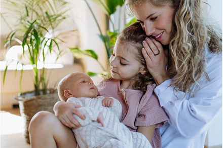 Girl hodling little baby, mother, a Person Photo by HalfPoint