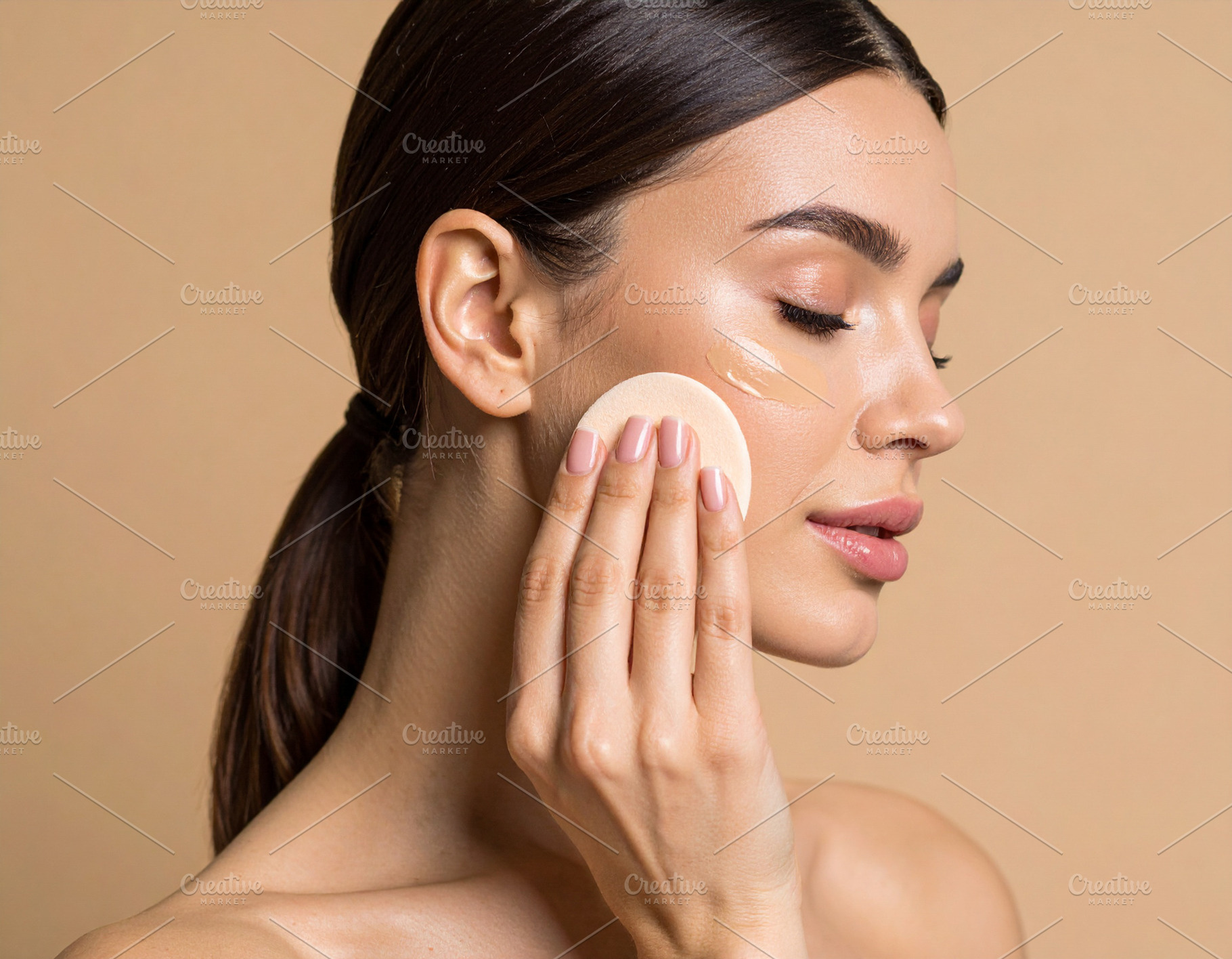 Woman applying liquid foundation under one eye using a sponge, a Beauty & Fashion Photo by DanFLCreativo