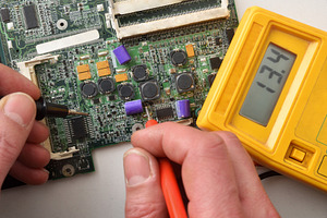 Man testing printed circuit board with multimeter top view, a Technology Photo by Davizro's Market