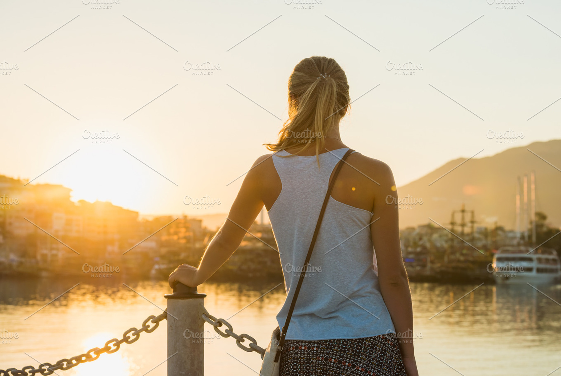 Young blond woman watching sunset featuring sunset, sea, and port, a Person Photo by Foxys