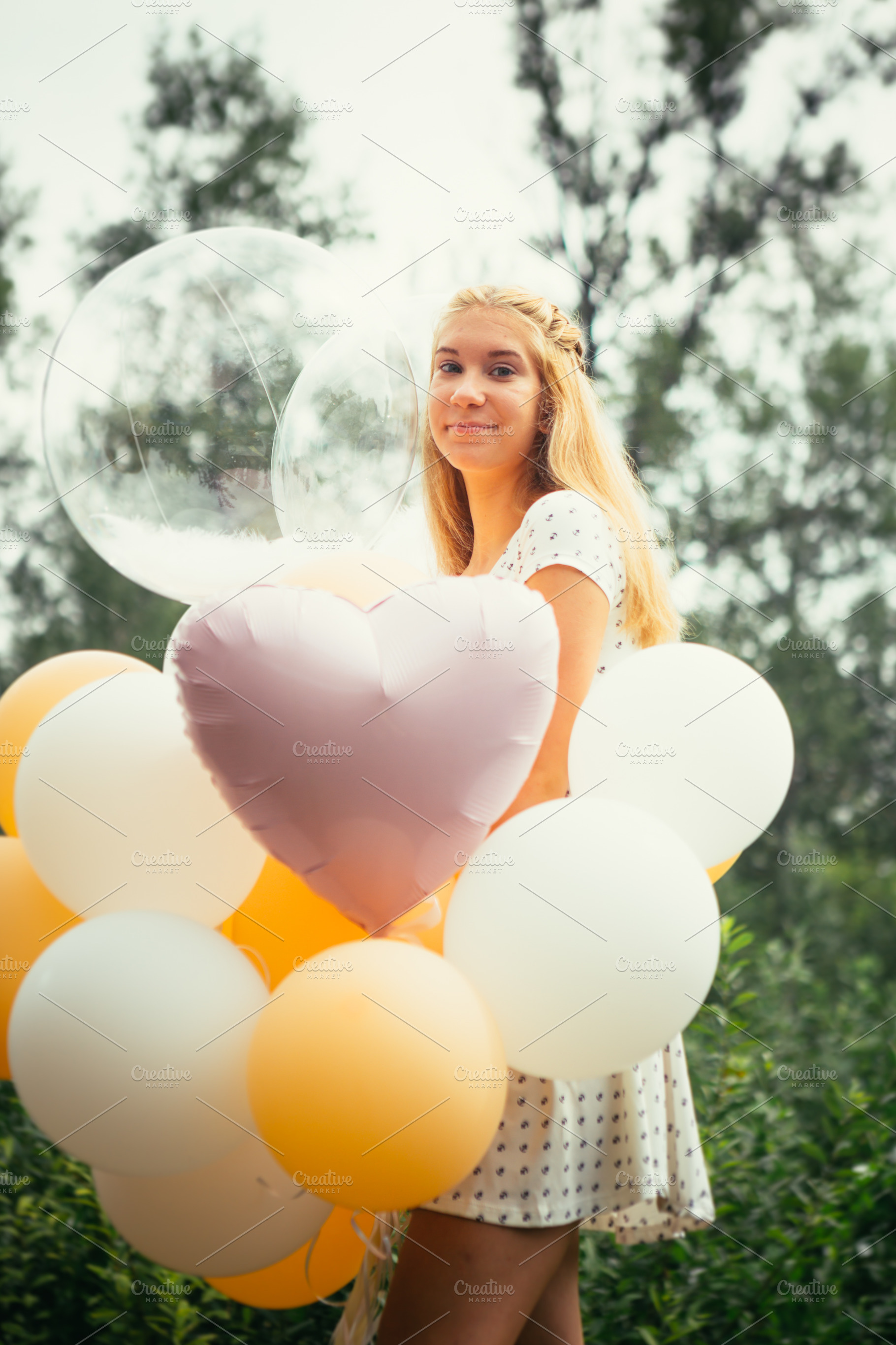 Young girl with balloons on nature b stock photo containing happy and woman, a Person Photo by ruslan117