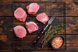 Uncooked pork loin medallion, cut tenderloin ready to be seasone, a Food & Drink Photo by composter-box@mail.ru