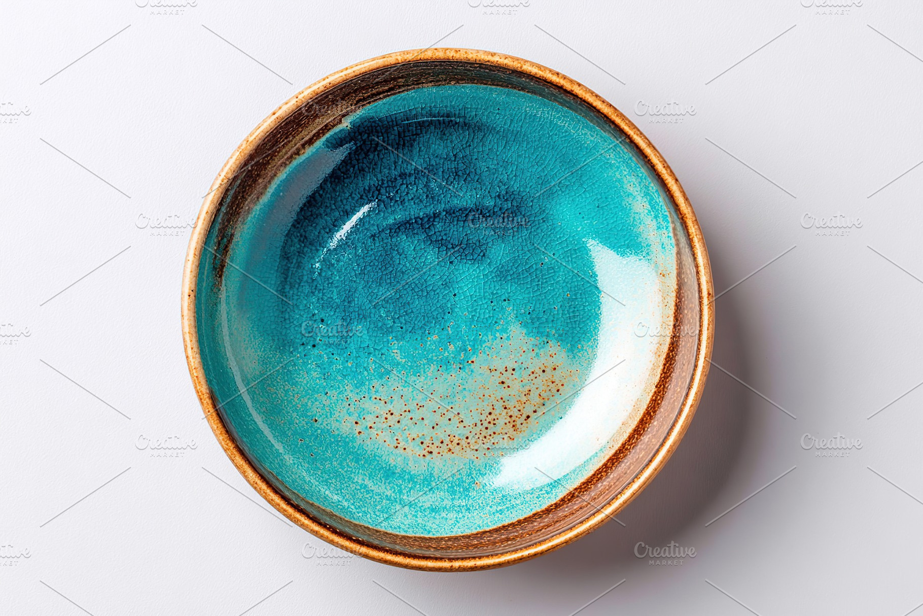 Elegant round ceramic plate with a stunning turquoise glaze in a minimalist sty, a Food & Drink Photo by AlyaAnd