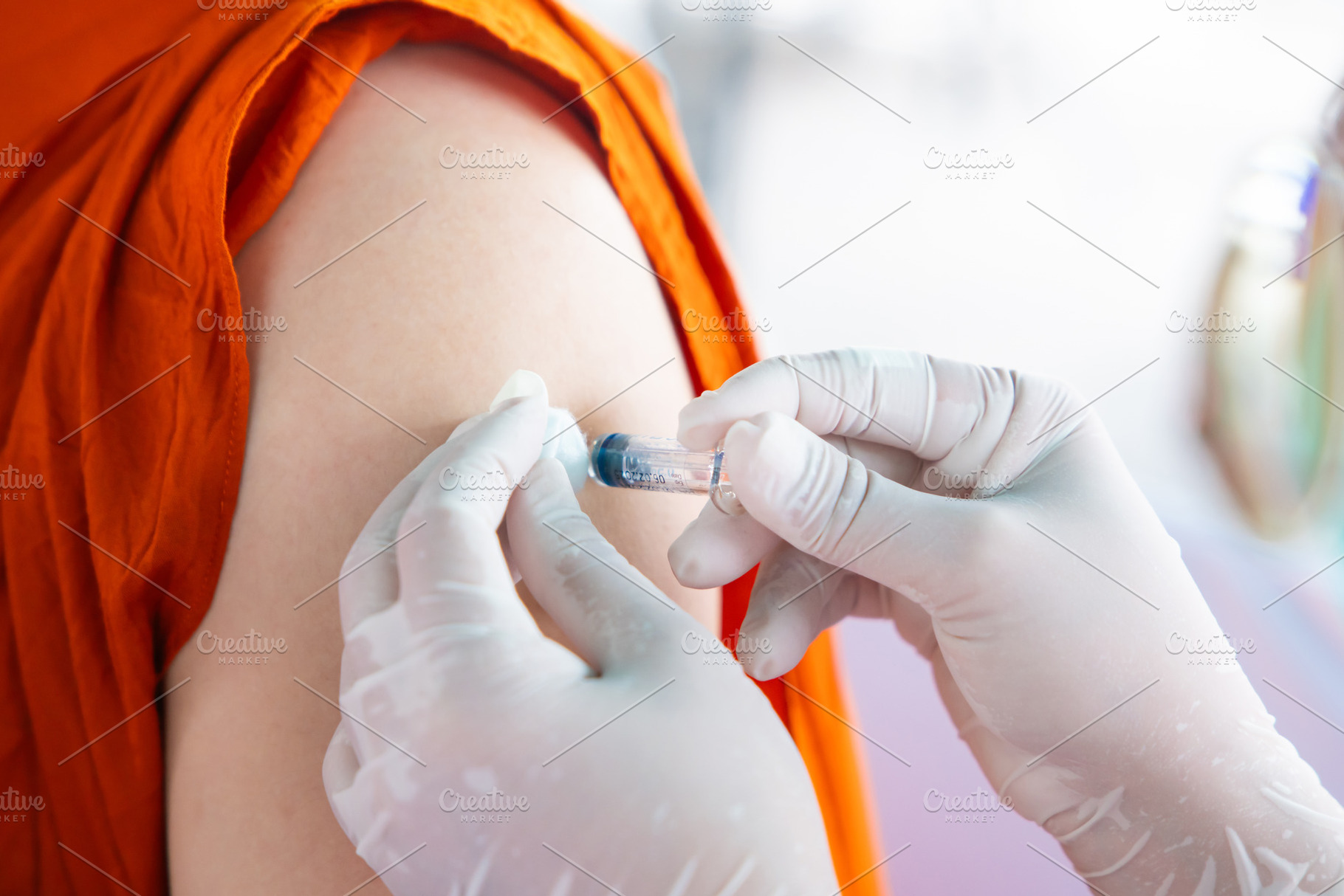 Nurse holding a syringe for the injection giving patient vaccine, a Health & Medical Photo by Casanowe-studio