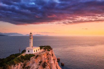 Lighthouse on the mountain peak at colorful sunset in summer, a Nature Photo by den-belitsky